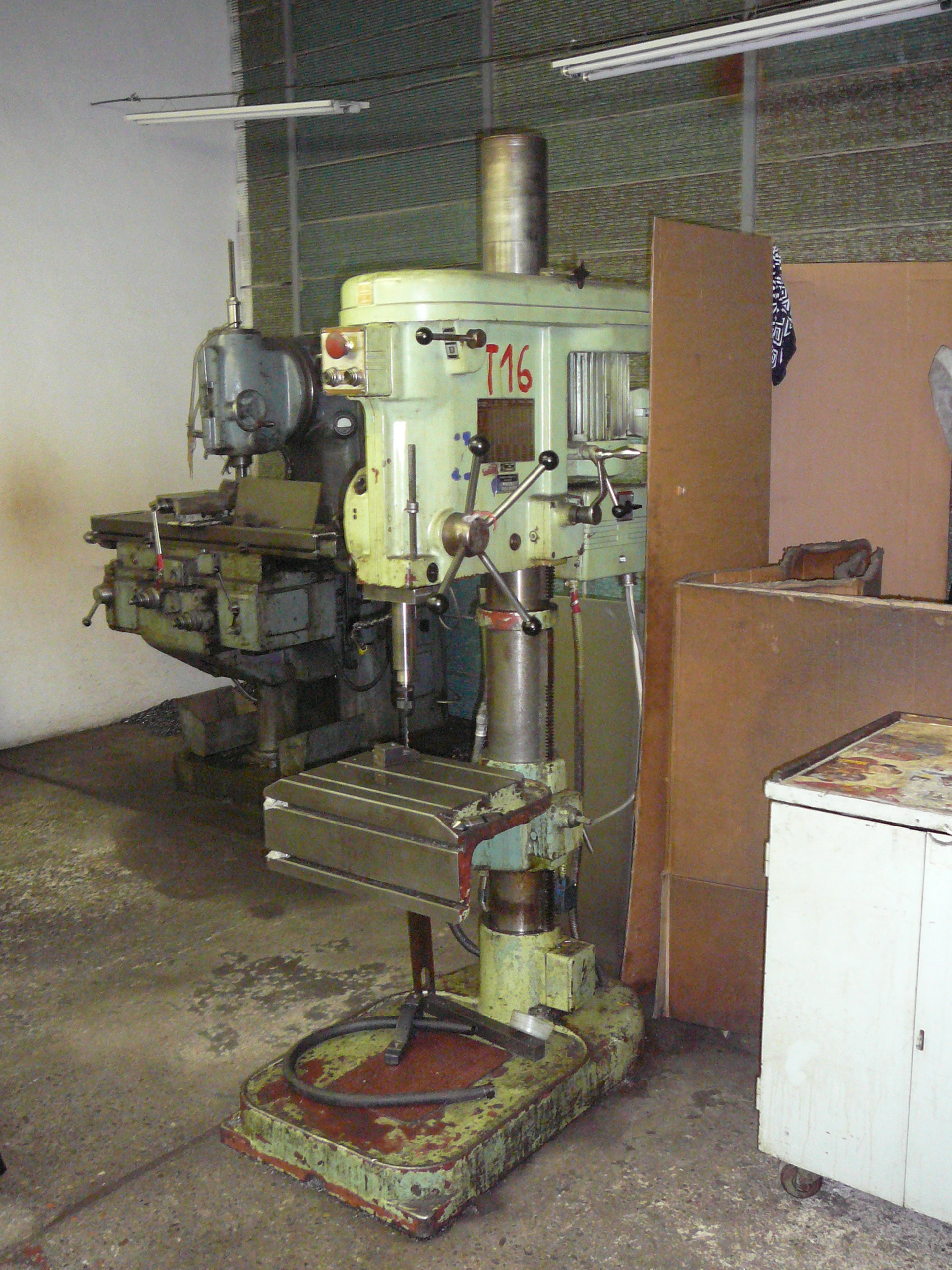 Students learning basic hand tool techniques with files and hacksaws at workbenches in the fabrication station