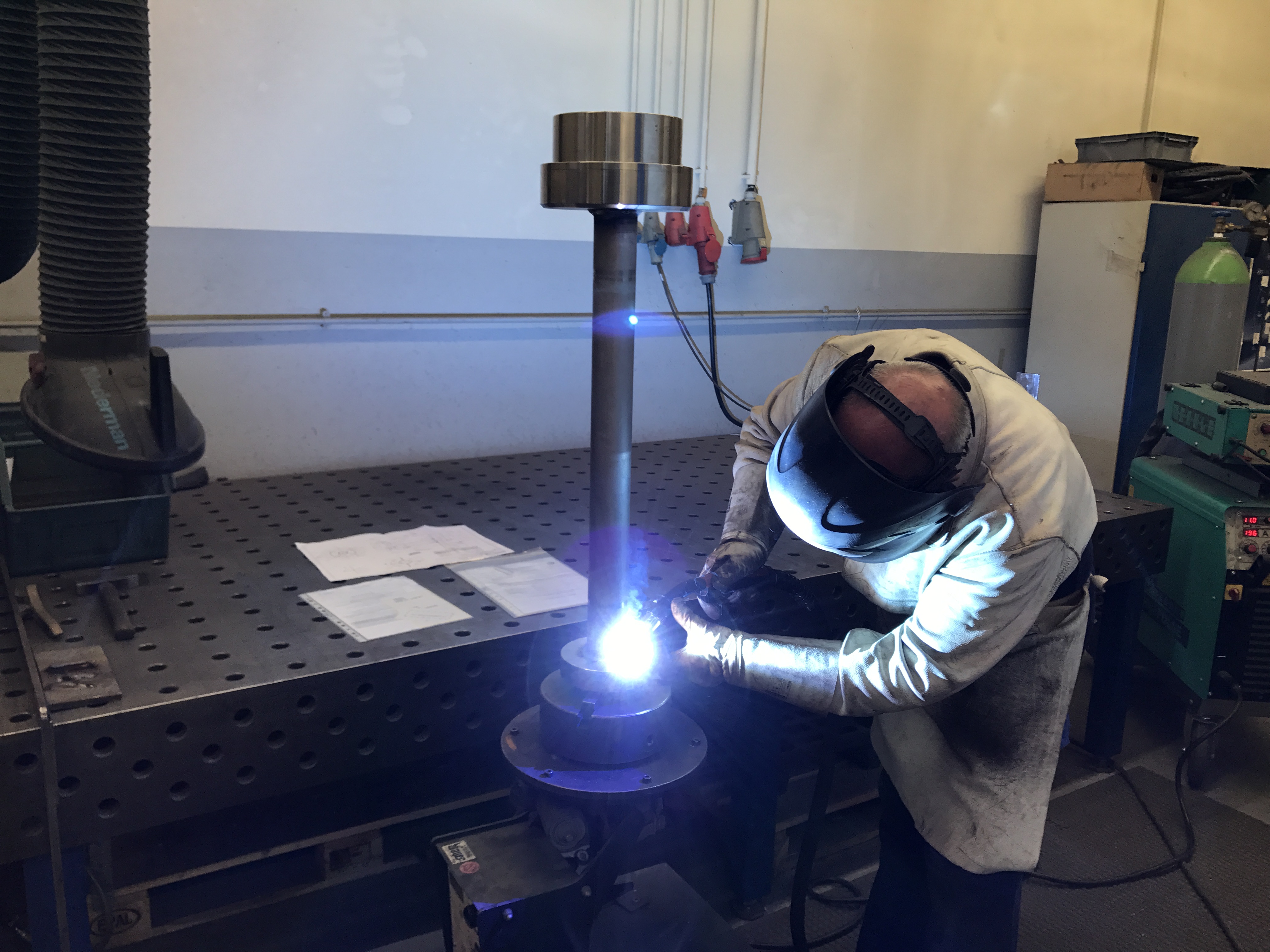 Student wearing mandatory overalls or boiler suit in workshop environment